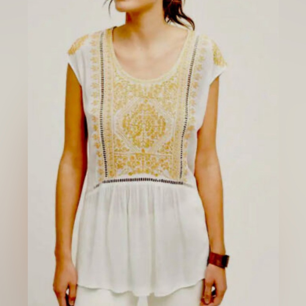 Anthropologie sleeveless top with yellow/ gold embroidered details.